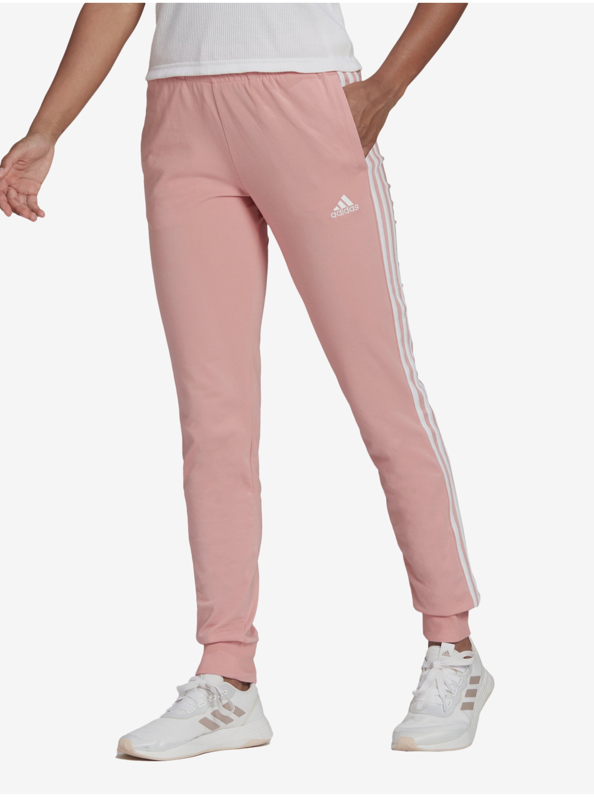 Levně Světle růžové dámské tepláky adidas Performance