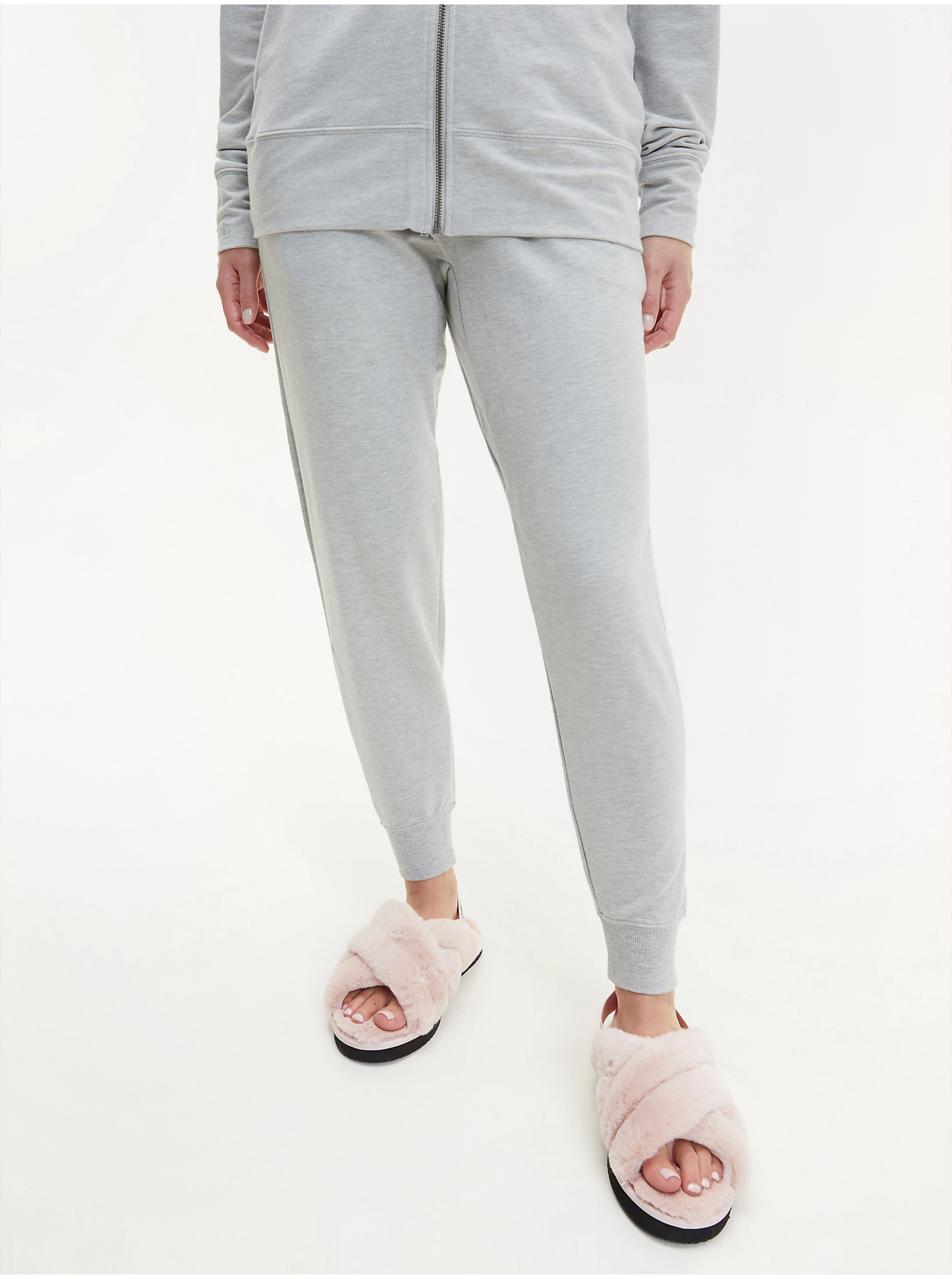 Levně Světle šedé dámské žíhané tepláky Calvin Klein Jeans