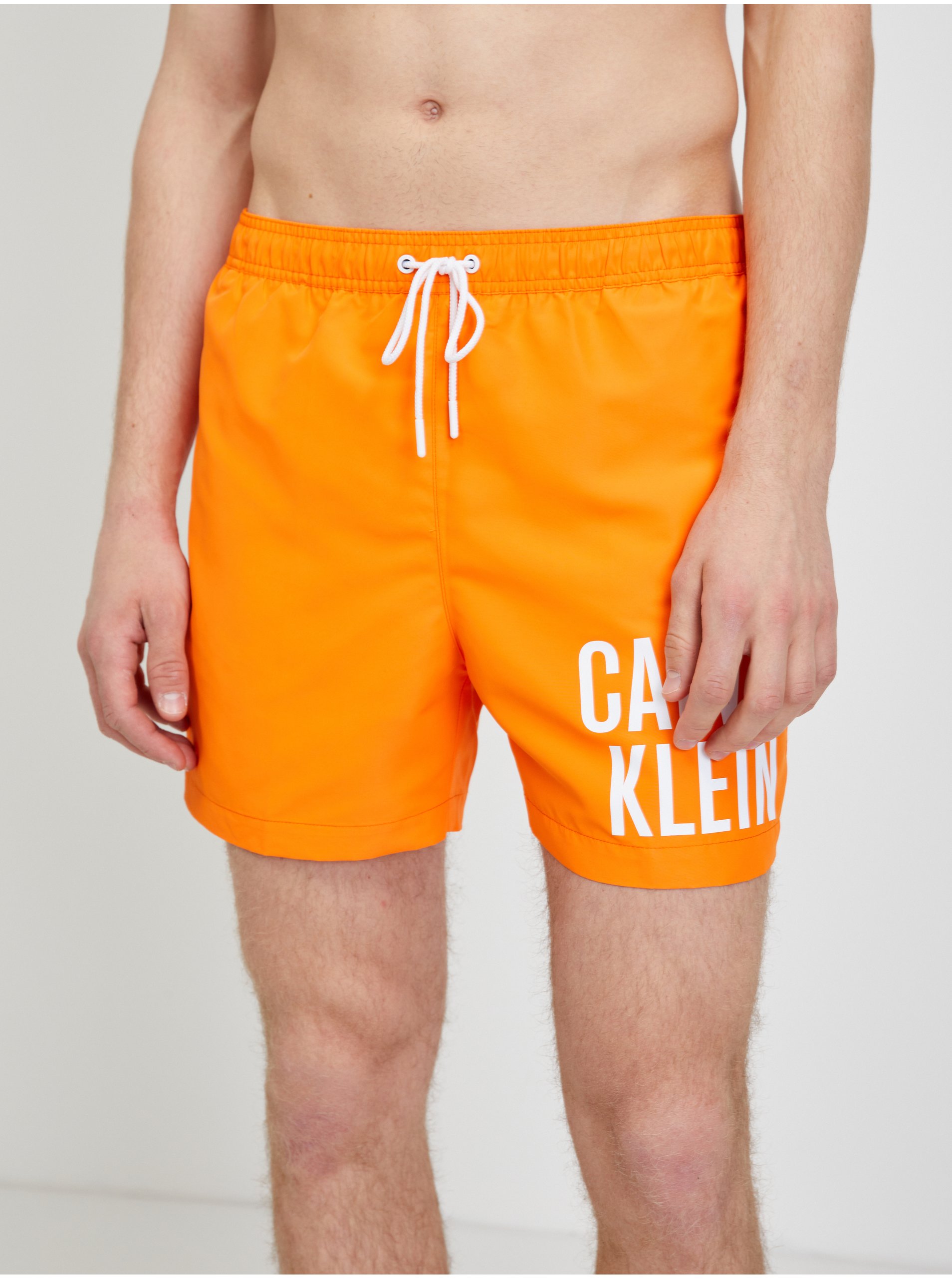 Lacno Oranžové pánske plavky Calvin Klein Underwear