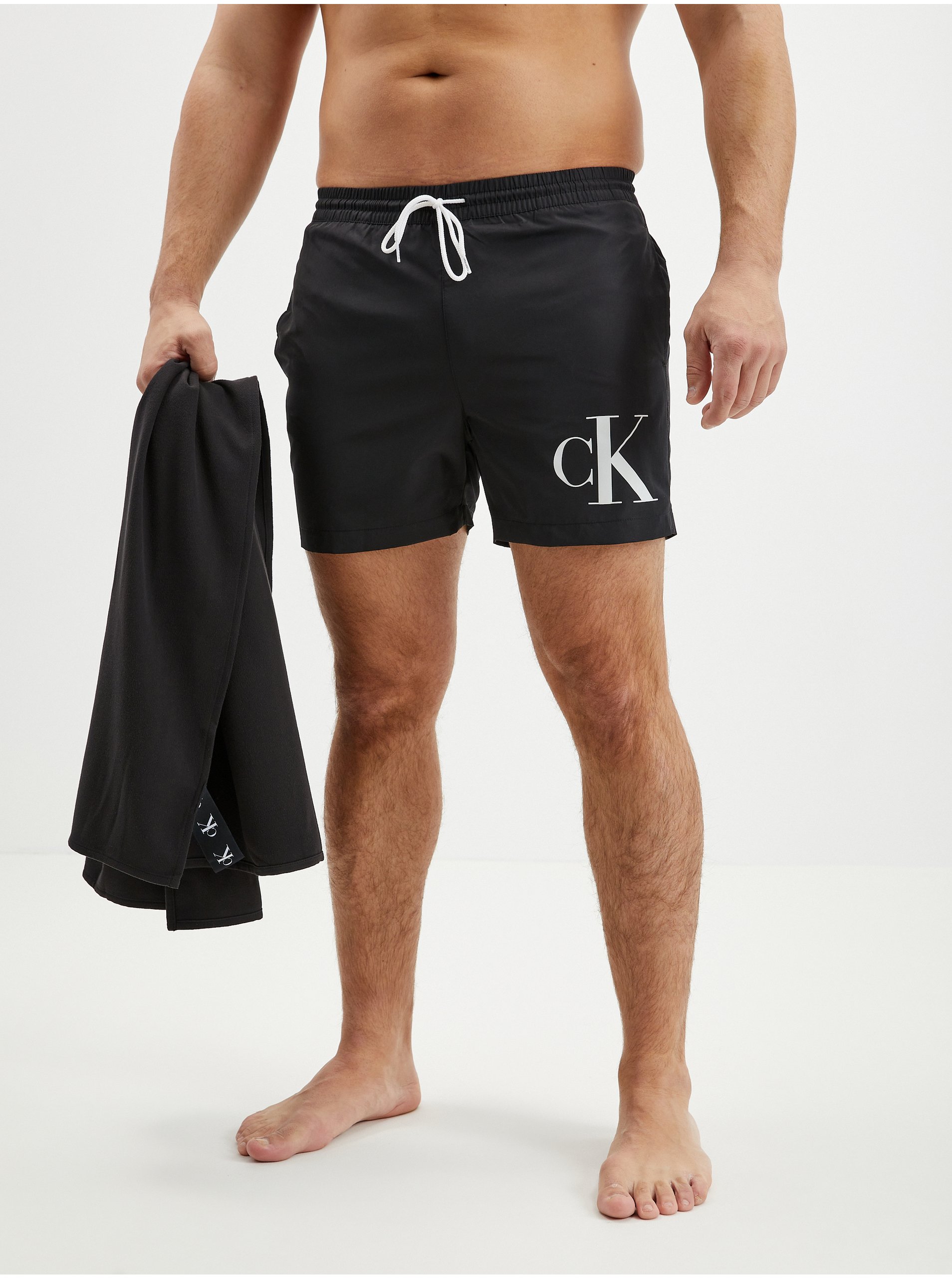 Levně Sada pánských plavek v černé barvě a ručníku Calvin Klein Underwear