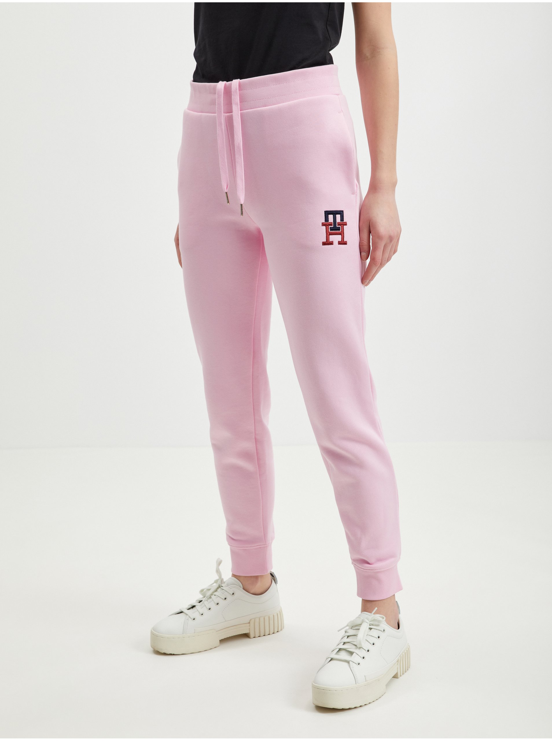 Levně Světle růžové dámské tepláky Tommy Hilfiger