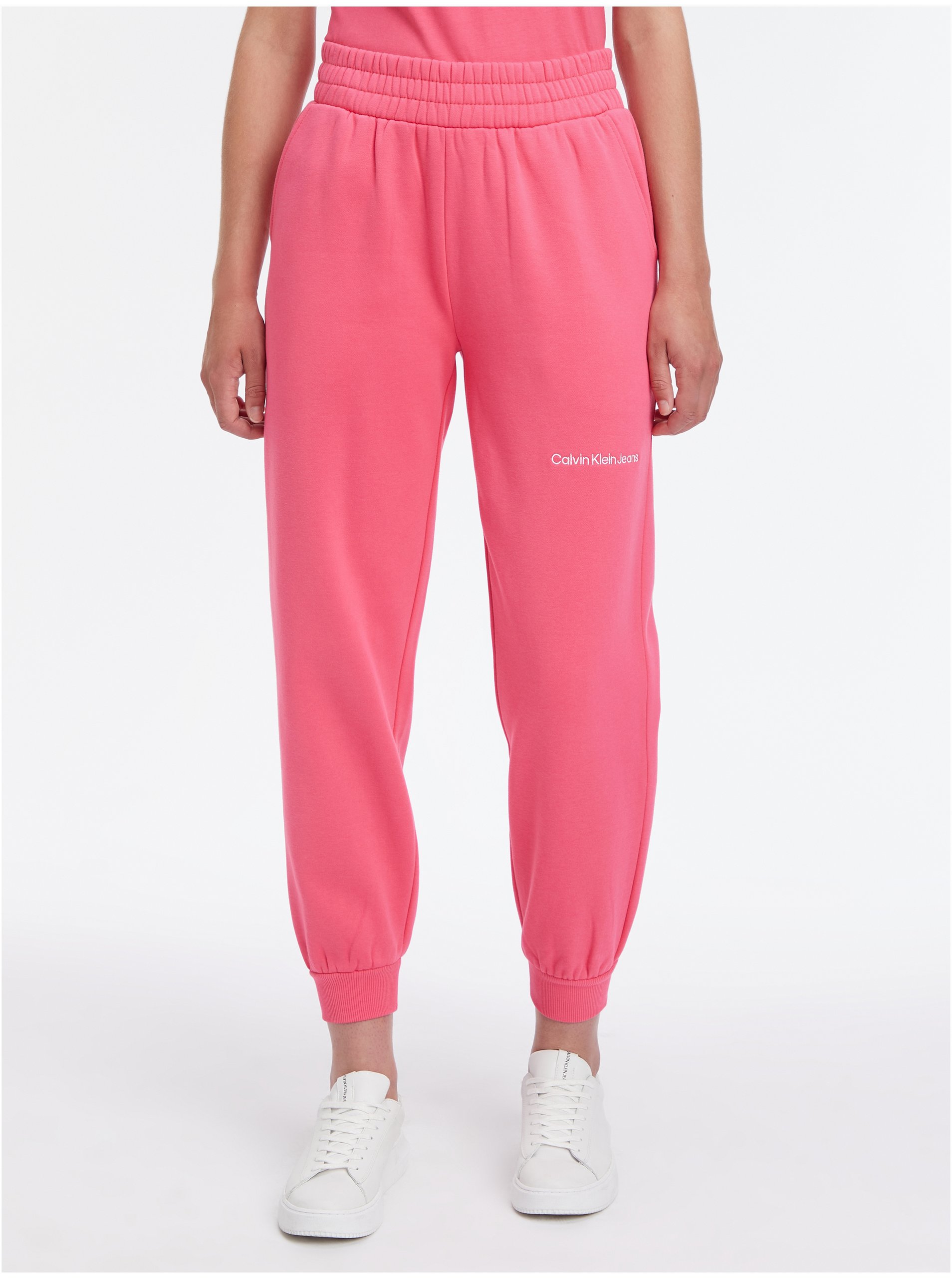Levně Tmavě růžové dámské tepláky Calvin Klein Jeans