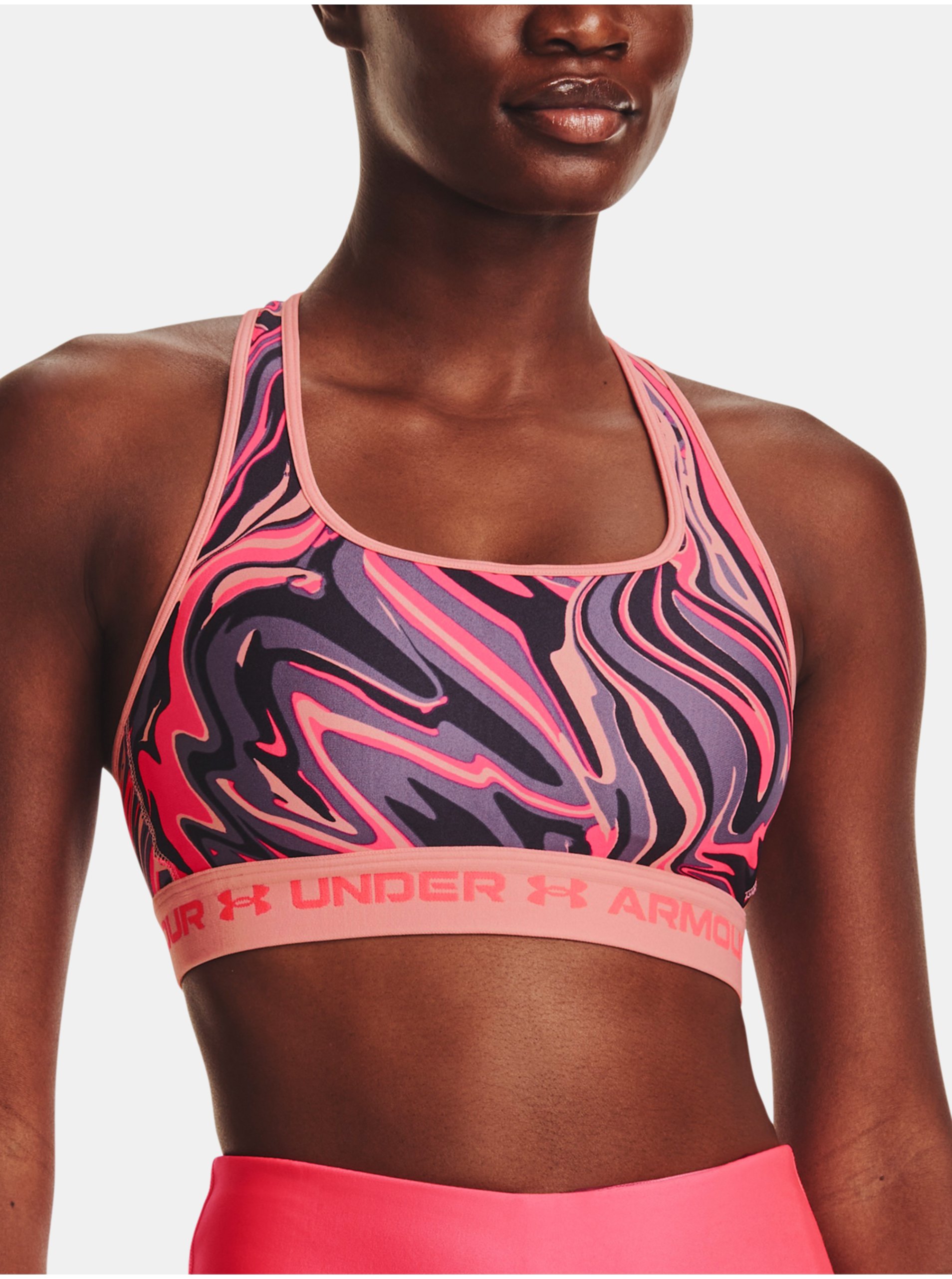 Levně Růžová vzorovaná sportovní podprsenka Under Armour UA Crossback Mid Print