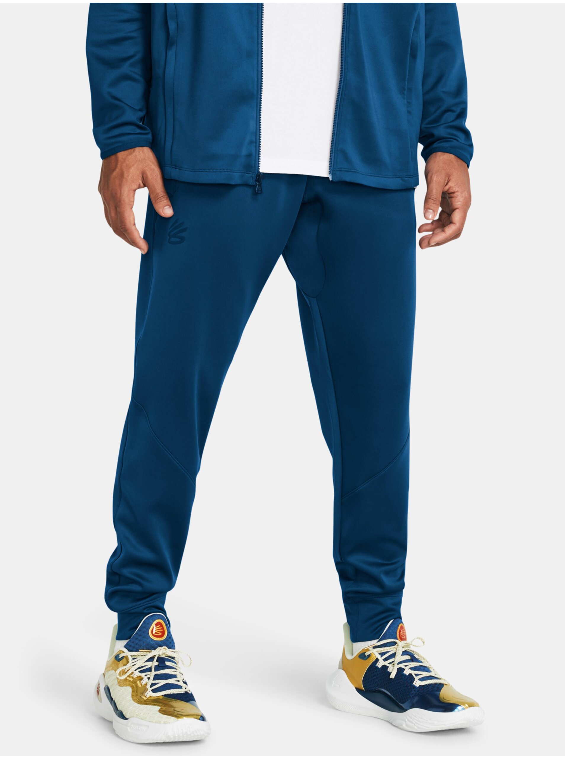 Levně Modré sportovní kalhoty Under Armour Curry Playable Pant